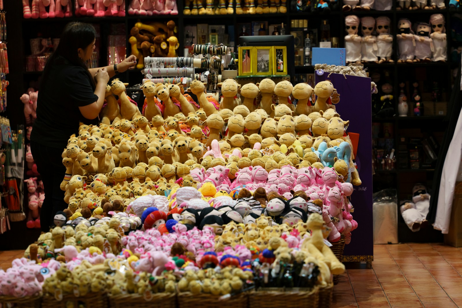 A person standing in front of a display of stuffed animals