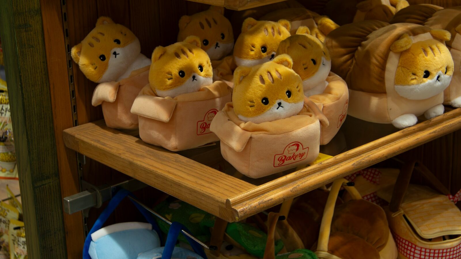 a bunch of stuffed animals that are on a shelf
